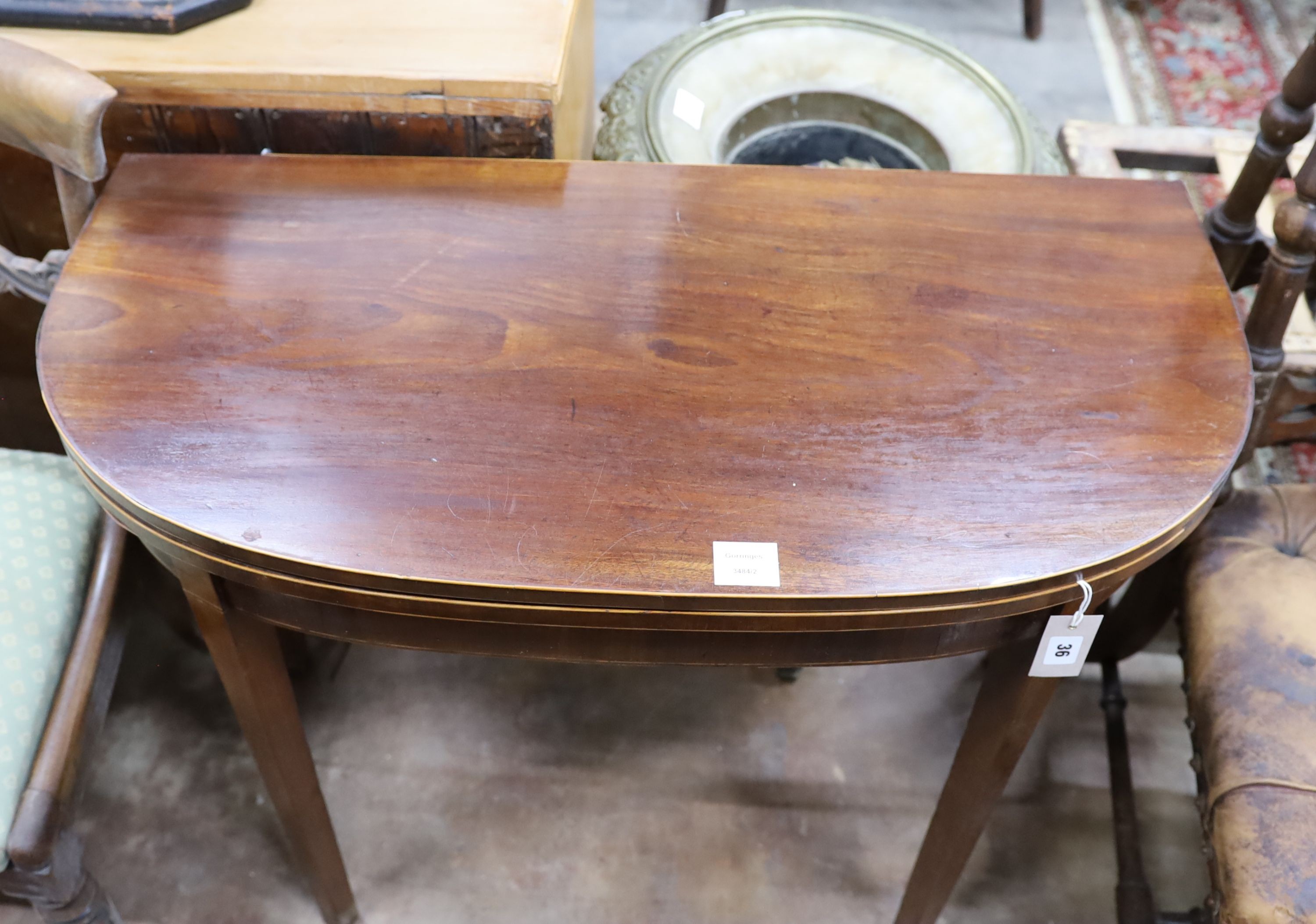 A George III inlaid mahogany D shaped folding card table, width 91cm, depth 45cm, height 74cm